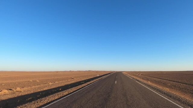 POV driving on desert highway, road trip with no traffic, concept of freedom and adventure