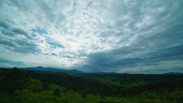 Time lapse shot of moving clouds and sunlight at rural area of Ruidoso in New Mexico