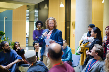 Male speaker on stage talking to audience