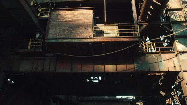 The old massive rusted part of a metallurgical factory revealing tons of steel, pipes, and amazing industrial architecture.