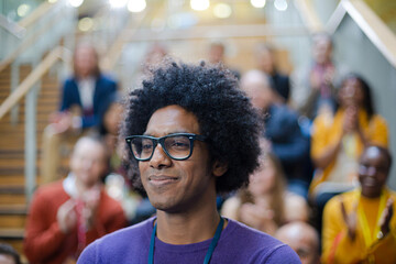 Male speaker smiling on stage