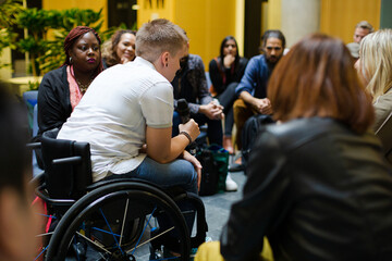 Fototapeta na wymiar Audience watching speaker in wheelchair talking on stage