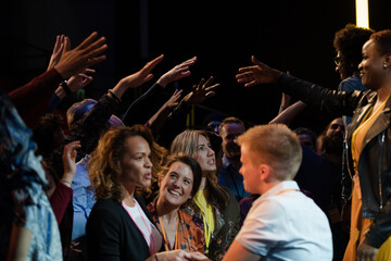 Audience reaching for and talking with speakers