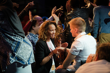 Audience reaching for and talking with speakers