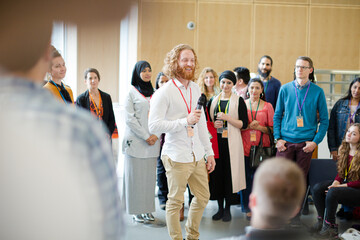 Male speaker with microphone talking on stage