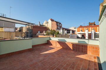 Empty terrace on the roof of modern building in Barcelona, Spain. View to the city and blue sky on sunny day.