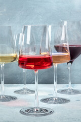 Rose, red and white wine in elegant modern glasses at a wine tasting at a winery. Winetasting event