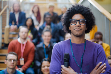 Male speaker smiling on stage