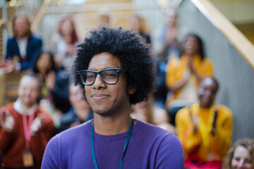 Male speaker smiling on stage