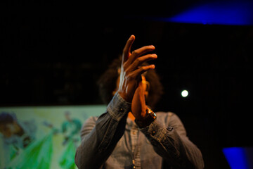 Male speaker on stage talking to audience