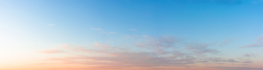 Blue sky with clouds at sunset, large panoramic shot.