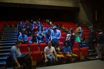Audience entering dark auditorium