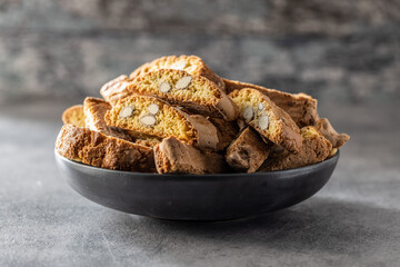 Italian cantuccini cookies on plate. Sweet dried biscuits with almonds.
