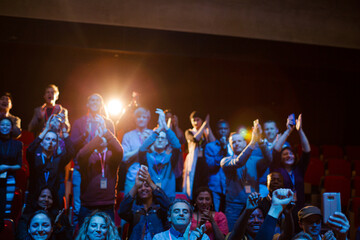 Smiling, excited audience cheering