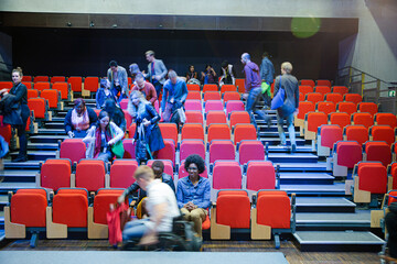 Audience arriving and sitting in auditorium