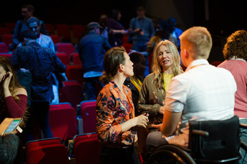 Audience talking to speaker in wheelchairs on stage