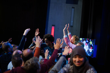 Fototapeta premium Audience reaching for and talking with speakers