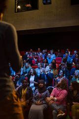 Male speaker on stage talking to audience