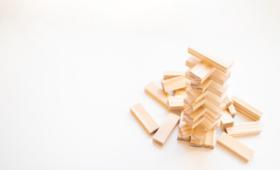 The tower stack from wooden blocks toy with sky background. Learning and development concept.