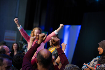 Fototapeta premium Audience reaching for and talking with speakers