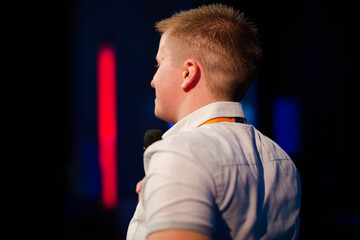 Female speaker in wheelchair on stage talking to audience