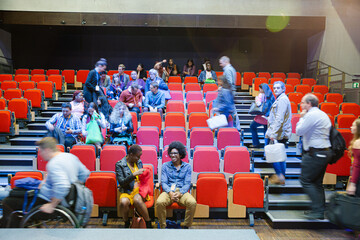 Audience arriving and sitting in auditorium