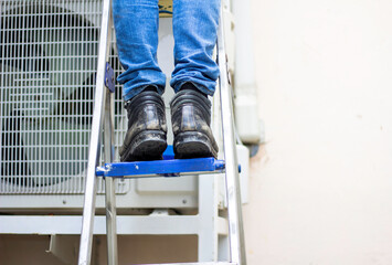 Wear safety shoes to ensure safety at work. construction workers wear safety shoes. concept. Construction workers work on the stairs