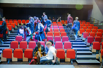 Audience arriving and sitting in auditorium