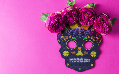 The concept of the background of the holiday dia de Muertos. Black festive mask skull with flowers...