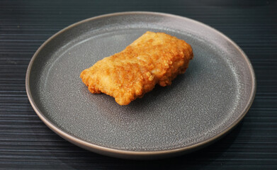 deep fried golden chicken chop cutlet fish fillet on dark grey wood background dim sum halal menu