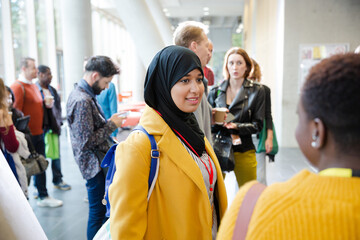 Smiling woman in hijab waiting for conference