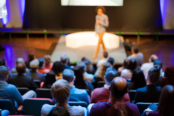 Male speaker with microphone talking to audience