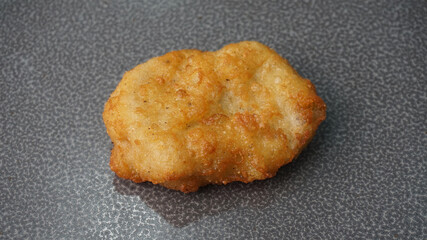 deep fried golden chicken nugget fritter with sauce on dark grey wood background dim sum halal menu