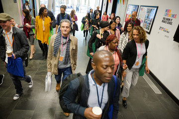 People walking down auditorium hall