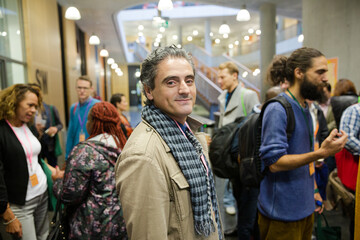 Smiling businessman in auditorium hall