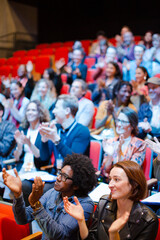 Smiling, happy audience clapping