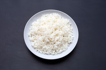 Dish of rice on dark background.