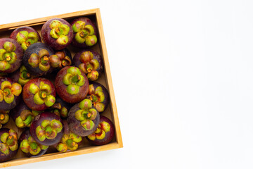 Mangosteen in wooden box on white background.