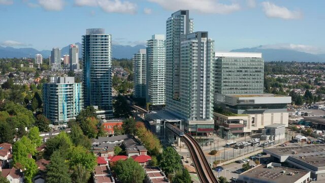 SkyTrain Leaving Marine Drive Station To North Arm Bridge In Vancouver, Canada Near YVR Airport. aerial pullback
