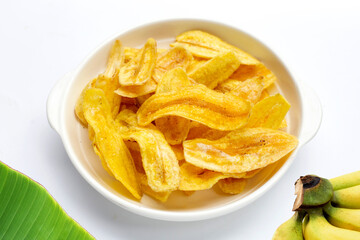 Banana slice chips in bowl on white background