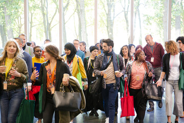 People walking down auditorium hall