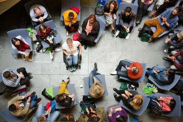 Fototapeta premium Male speaker in wheelchair talking to audience