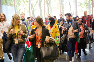 People walking down auditorium hall
