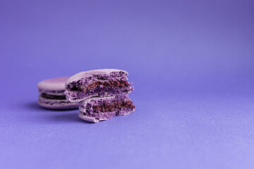 Violet macaroni broken into two halves close-up. French dessert for Halloween.