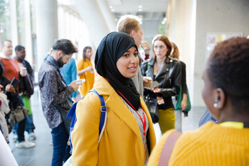 Smiling woman in hijab waiting for conference