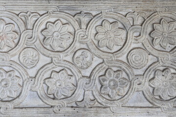 Ancient Carved Stone Fragment with Flowers at Santa Maria in Trastevere Basilica in Rome, Italy