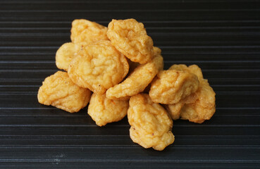 deep fried golden fish prawn ball seafood in dry or soup bowl on dark grey wood background dim sum halal menu