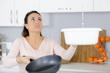homeowner watching ceiling leaks sitting on a couch at home