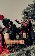 Battle between two ancient warriors in battle dress on meadow.