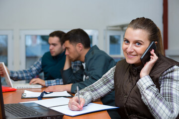 smiling manager on the phone holding a document